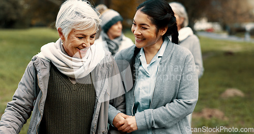 Image of Happy, walking and a woman and caregiver in nature for talking, support and relax in the morning. Help, together and a young carer speaking to a senior patient in a park or garden for bonding