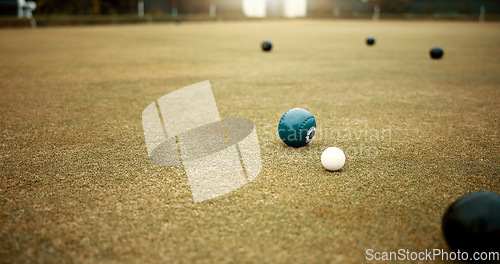 Image of Green, balls and game of lawn bowling on grass, field or pitch in match or competition of outdoor bowls. Ball, moving and sport tournament at bowlers club, league or championship games on the ground