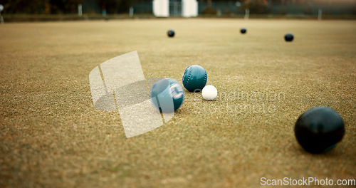 Image of Green, balls and lawn bowling game on grass, field or pitch in a match or competition of outdoor bowls. Ball, moving and sport tournament at a bowlers club, league or championship games on the ground