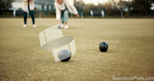 Image of Women, park or old people bowling for fitness, training or exercise for wellness or teamwork outdoors. Senior ladies, relax or elderly friends playing fun ball game or sport in workout together