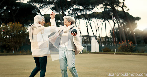 Image of Senior women, high five and park for sport, lawn bowling and happy for fitness, goal and celebration in nature. Teamwork, elderly lady friends and metal ball for games, contest and winning together