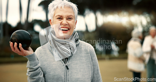 Image of Senior woman, lawn bowling and park with face for sport, fitness or game for competition, health or fun. Elderly lady, metal ball and grass for contest, excited smile or workout in outdoor portrait