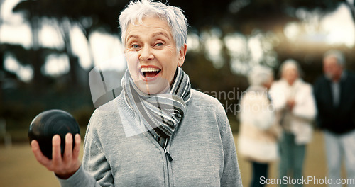 Image of Senior woman, lawn bowling and park with face for sport, fitness or game for competition, health or fun. Elderly lady, metal ball and grass for contest, excited smile or workout in outdoor portrait