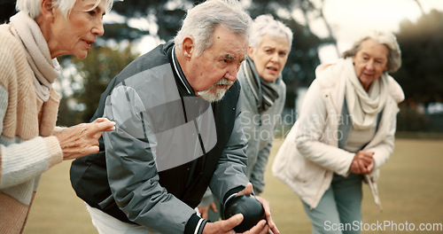 Image of Senior man, game and senior people bowling in nature for retirement sports, teamwork and support. Bowling, friends and elderly man and woman in a group with a ball for a competition on a field togeth