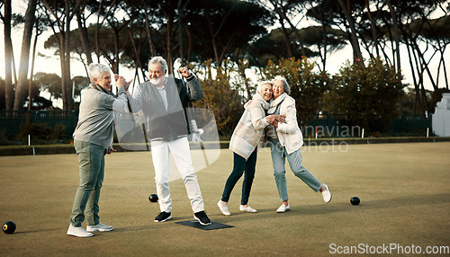 Image of Bowls, high five and celebration with senior friends outdoor, cheering together during a game. Motivation, support or applause and a group of elderly people cheering while having fun with a hobby