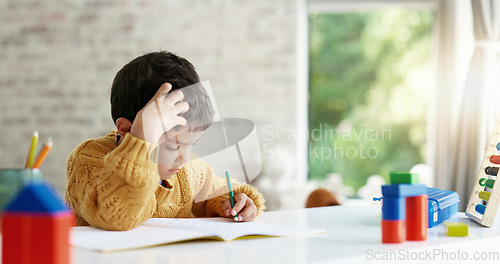 Image of Child, drawing or boy writing homework on notebook in kindergarten education for growth development. Project, creative or young art student with color pencil learning or working on sketching skills