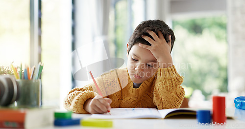 Image of Child, drawing or boy writing homework on notebook in kindergarten education for growth development. Project, creative or young art student with color pencil learning or working on sketching skills