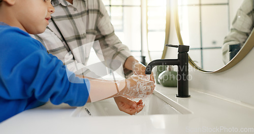 Image of Woman, child and washing hands in bathroom, cleaning to prevent germs and dirt in home with soap, water and hygiene. Kid, mom and hand wash, teaching, learning and clean morning routine with family.