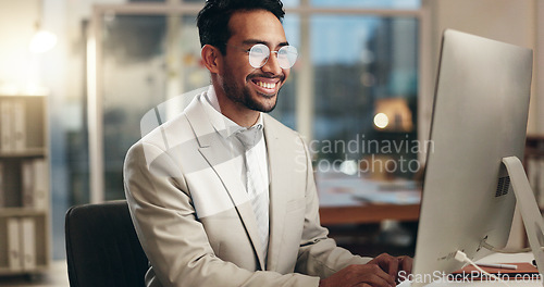 Image of Office computer, night and happy man typing email, communication and networking with business consultant. Smile, reading and professional person contact social media user, network admin or employee