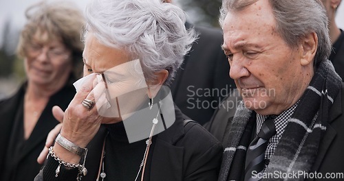 Image of Death, funeral and senior couple crying together in pain or grief for loss during a ceremony or memorial service. Tissue for tears, support or empathy with an elderly man and woman feeling compassion