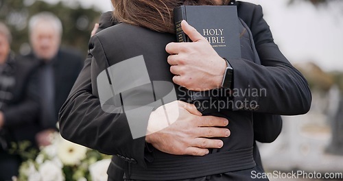 Image of Funeral, graveyard and people hug for comfort, empathy and support at memorial service in cemetery. Depression, grief and sad man and woman for goodbye, mourning and burial for death with bible