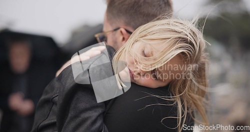 Image of Sad, death and a daughter with her father at a funeral for grief or mourning loss together outdoor. Family, empathy and a man holding his girl child at a memorial service or ceremony for condolences