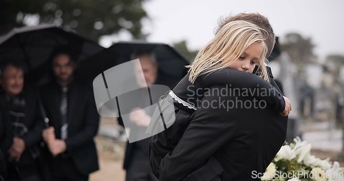 Image of Sad, hug and a father and child at a funeral with depression and mourning at the graveyard. Holding, young and a dad with care and love for a girl kid at a cemetery burial and grieving together