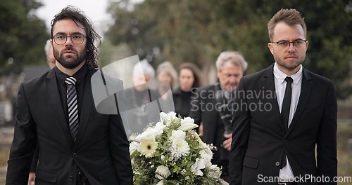 Image of Pallbearers, men and walking with coffin at graveyard ceremony outdoor at burial place. Death, grief and group of people with casket at cemetery for funeral and family service while mourning at event