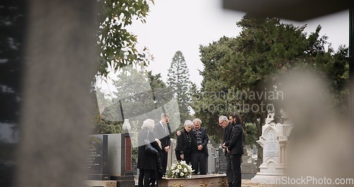 Image of People at a funeral, death and graveyard with family mourning outdoor, grief and loss with coffin. Cemetery, ceremony and sad, goodbye and burial service with support, comfort and empathy at memorial