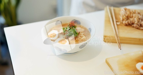 Image of Ramen noodles, eggs and chopsticks on table in restaurant for lunch, meal or diet in plate. Bowl, food and nutrition with soup in cafeteria with catering service for dinner, snack or health in Tokyo