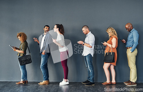 Image of Businesspeople, waiting and queue with technology for hiring, job recruitment or onboarding. Men, women and corporate diversity in line with cellphone for staff interview, human resources or meeting