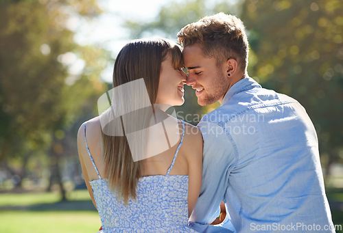 Image of Couple, nose touch and relax in park with happiness outdoor, love and commitment for healthy relationship. Romantic date in nature, eskimo kiss and people with smile together in public garden