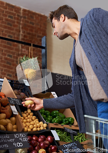 Image of Potato, food and man shopping at a supermarket for grocery promotions, sale or discounts deal. Check, fresh or customer buying groceries for healthy nutrition, organic vegetables or diet with choice