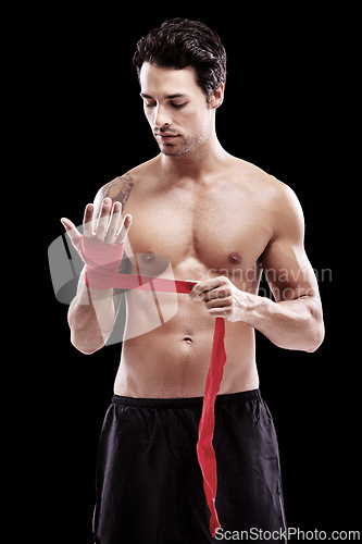 Image of Man, hand wrap and fitness with boxer in a studio ready for boxing training and workout. Body, athlete and male fighter from Brazil with exercise, sport and wellness for battle with black background