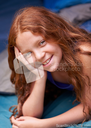 Image of Tent, camping and portrait of child in sleeping bag for resting, relax and comfortable. Travel gear, youth and happy ginger girl in sleep sack for adventure on holiday, vacation and weekend outdoors