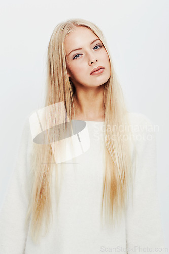 Image of Woman, portrait and fashion for natural beauty, style or haircare on a white studio background. Face of young female person, blonde or attractive model in casual clothing with makeup and cosmetics