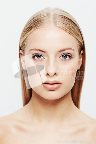 Image of Portrait, woman and beauty or cosmetic in studio, confident and cosmetology for facial skin treatment. Young model, face and shine in self care or blonde hair and organic makeup by white background