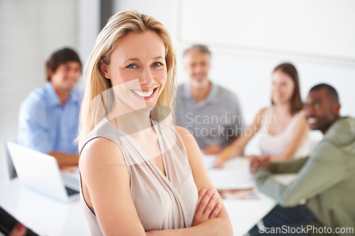 Image of Business woman, portrait and group with arms crossed, startup company or smile with pride in boardroom. Person, leader and meeting in modern office for workshop, discussion and negotiation at agency