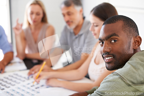 Image of Magazine, design and portrait of man in meeting with team project, collaboration and creative planning. African, person and photographer work at table with catalog, portfolio and editing process