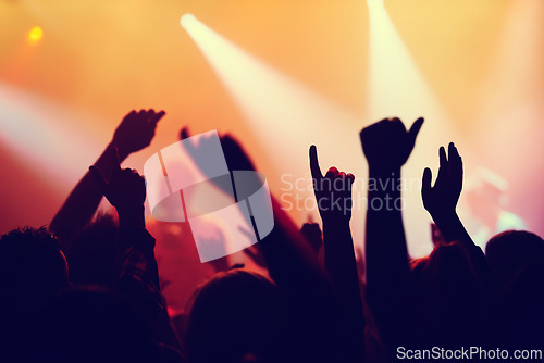Image of Party, concert and hands of people in audience or crowd with energy for dance event at night. Music, light and festival with group of fans at rock or disco performance on stage for celebration