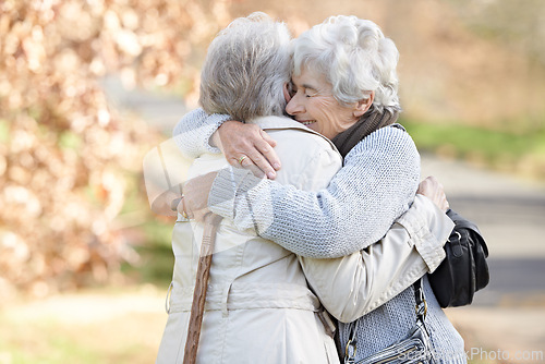 Image of Nature, love and senior friends hugging for support, bonding or care in outdoor park or garden. Happy, smile and elderly women in retirement embracing for greeting, connection or trust in field.