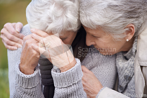 Image of Senior women, friends and crying in nature, embrace and grief in outdoor environment. Elderly people, garden and comfort in peaceful park for affection, sadness and hugging for care in retirement