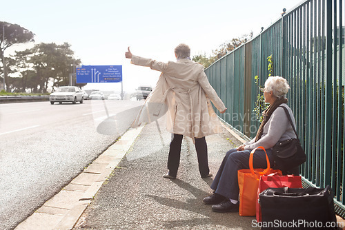 Image of Senior people, hitchhiking and traveling on road, retirement and waiting for taxi or cab in city. Elderly women, back and outdoor journey or trip in town, friends and roadside assistance on street