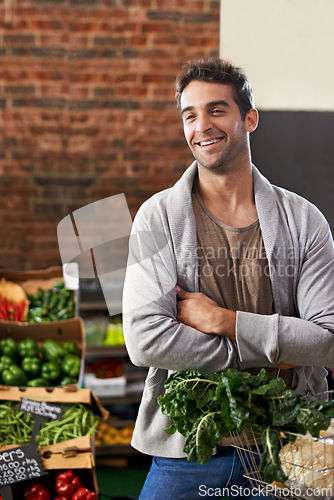 Image of Smile, healthy food or happy man shopping in supermarket for grocery sale or discounts deal. Arms crossed, thinking or customer buying fresh produce for diet nutrition, organic vegetables or spinach