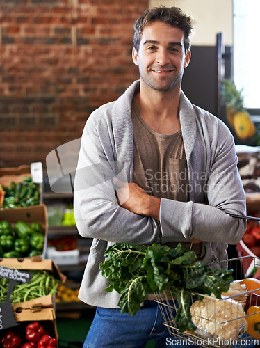 Image of Portrait, healthy food or happy man shopping in supermarket for grocery sale or discounts deal. Arms crossed, smile or customer buying fresh produce for diet nutrition, organic vegetables or spinach