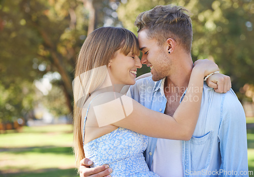 Image of Couple, nose touch and hug in park with happiness outdoor, love and commitment for healthy relationship. Romantic date in nature, loyalty or respect with people and smile together in public garden