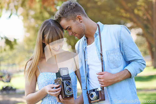 Image of Retro camera, nature or couple check results of vintage photography, photo memory or creative photoshoot. Antique equipment, tourist or nature photographer looking at garden picture for media project