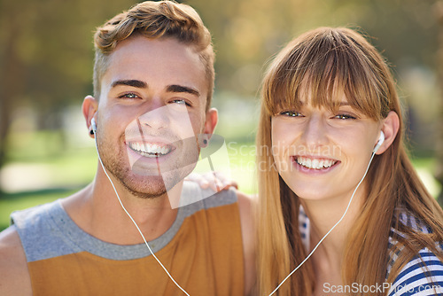 Image of Couple, smile in portrait and earphones outdoor for music and entertainment, technology and romantic date in park. People listening to radio, podcast or streaming online with happiness in nature