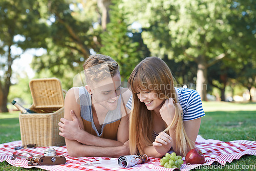 Image of Picnic, love and couple on blanket in park for bonding, relationship and relax on date outdoors. Happy, dating and man and woman on grass with food for lunch, meal and eating in nature for romance
