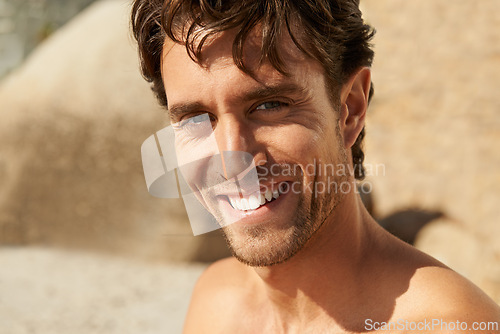 Image of Man, smile and portrait at the beach on a holiday and summer vacation outdoor with travel. Happy, sea and male person from California by the ocean with confidence and freedom from trip and journey