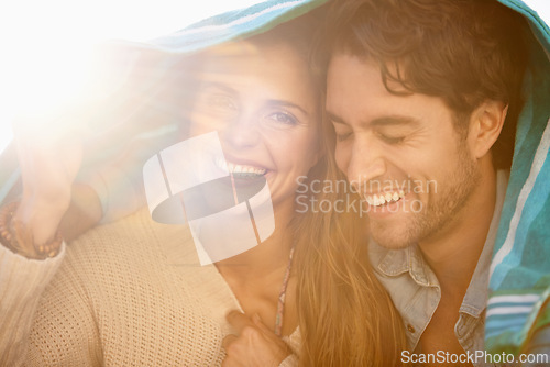 Image of Couple, towel cover head and outdoor with smile, care and embrace for holiday in summer sunshine. Man, woman and portrait with bonding, happy and relax with love with tourism, vacation and break