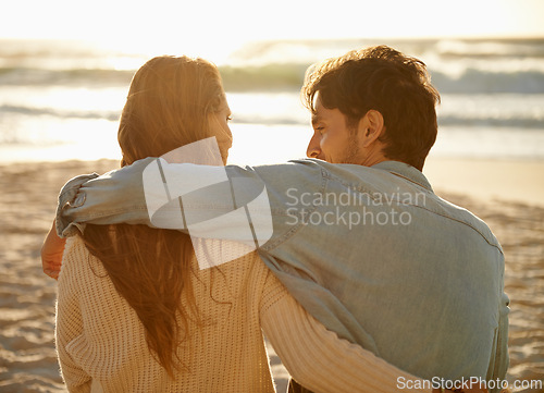 Image of Beach hug, sunset and couple relax with summer sunshine, wellness and bonding on travel holiday in Greece. Embrace, marriage love and back of people connect with soulmate on anniversary or vacation