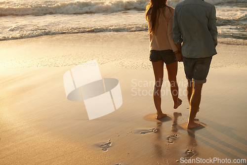 Image of Beach, sunset and couple holding hands on walk, sand journey or travel holiday for outdoor wellness in Portugal. Mockup space, love and back of partner, soulmate or people on romantic tropical island