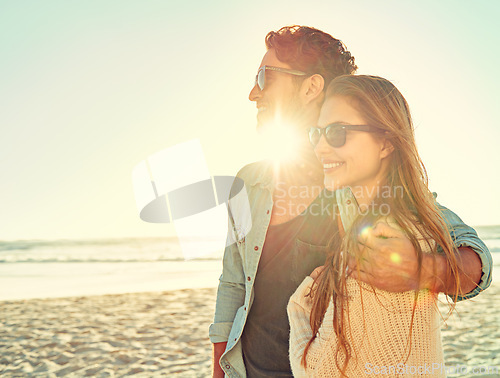 Image of Sunset, travel and couple hug at a beach with love, adventure and bonding in nature together. Sunrise, lens flare and people embrace at the sea for ocean view, summer and romance on Miami vacation