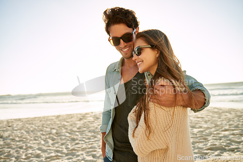 Image of Happy, travel and couple hug at a beach with love, adventure and bonding in nature together. Care, comfort and people embrace at the sea for ocean view, summer and romance on Miami vacation trip