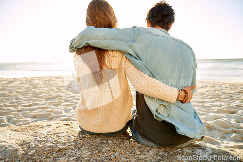 Image of Beach hug, view and couple relax on sand rock with summer sunshine, wellness or travel holiday in Argentina. Embrace, marriage love and back of people on honeymoon, vacation and looking at sea waves