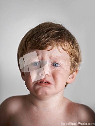 Image of Sad toddler, anxiety and portrait of baby in his home with emotional problem or loss in childhood. Crying, trouble and house with a frustrated young male kid, infant or boy with tears, fear or crisis