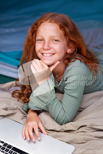 Image of Child, relax and portrait with laptop in bed with happiness to play online games for holiday or vacation. Kid, smile and scroll on computer website, streaming movie or elearning with internet