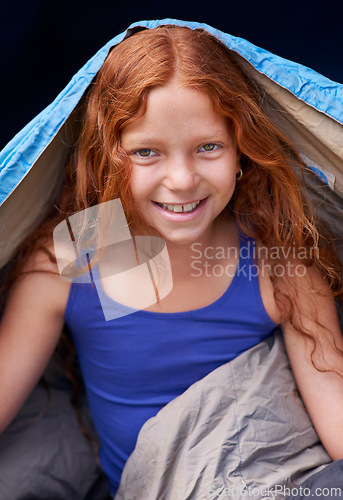 Image of Happy, camping and portrait of child in sleeping bag for resting, relax and comfortable in tent. Travel gear, ginger and girl in sleep sack for adventure on holiday, vacation and weekend outdoors