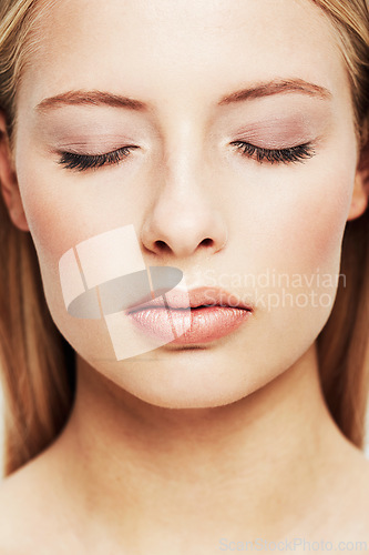 Image of Woman, face and closeup of skincare, beauty or makeup cosmetics for dermatology or cosmetology. Young female person with closed eyes for facial treatment, spa or salon for foundation or skin glow